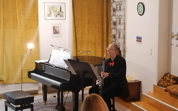 Woman playing a solo composition on a German heckelphone.